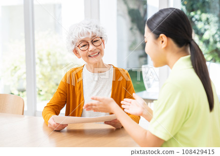 Senior woman consulting with care manager Senior woman consulting with care manager 108429415