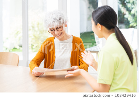 Senior woman consulting with care manager Senior woman consulting with care manager 108429416