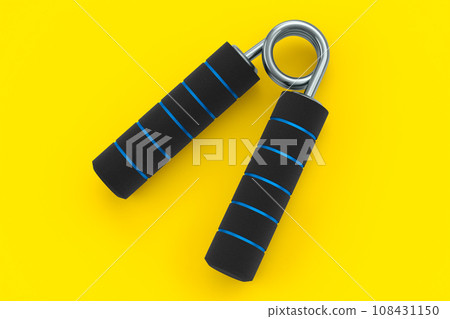 Iron hand expander or resistance band with rubber handle isolated on yellow. Iron hand expander or resistance band with rubber handle isolated on yellow. 108431150