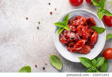 Bowl with sun dried tomatoes with fresh herbs and spices. Bowl with sun dried tomatoes with fresh herbs and spices. 108431841