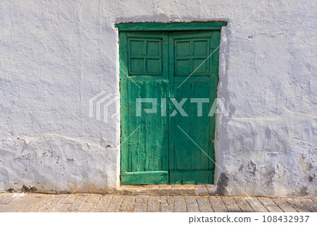 Image of an old Mediterranean green wooden door in a historic village Image of an old Mediterranean green wooden door in a historic village 108432937