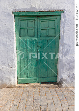 Image of an old Mediterranean green wooden door in a historic village Image of an old Mediterranean green wooden door in a historic village 108432938