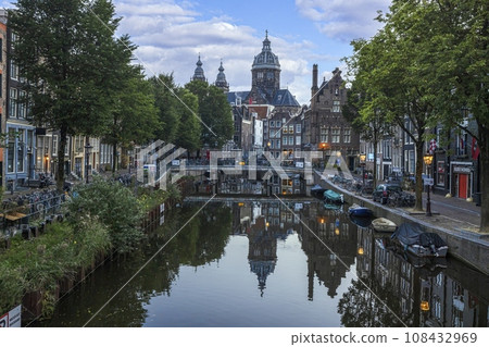 Image of St Nicholas Basilica in Amsterdam with adjacent canal in summer 2023 Image of St Nicholas Basilica in Amsterdam with adjacent canal in summer 2023 108432969