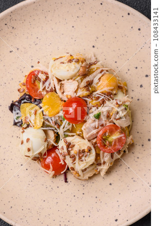 Delicious fresh salad with chicken, quail eggs, cherry tomatoes, lettuce 108433141