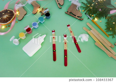 Step by step instruction how to make christmas toy from ice cream sticks. Step 4 with the help of plasticine balls, we make a nose, eyes and a Santa Claus belt. Children's New year handmade craft Step by step instruction how to make christmas toy from ice cream sticks. Step 4 with the help of plasticine balls, we make a nose, eyes and a Santa Claus belt. Children's New year handmade craft 108433367