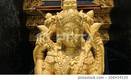 Balinese Hindu God golden Shiva Durga statue on a sacred Hindu temple in Indonesia Balinese Hindu God golden Shiva Durga statue on a sacred Hindu temple in Indonesia 108434520