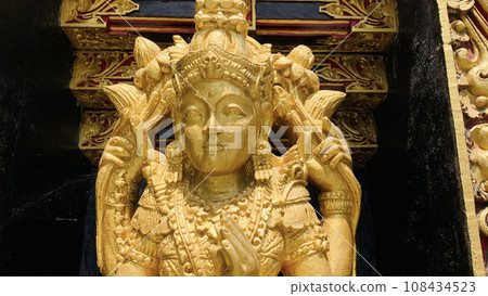 Balinese Hindu God golden Shiva Durga statue on a sacred Hindu temple in Indonesia Balinese Hindu God golden Shiva Durga statue on a sacred Hindu temple in Indonesia 108434523