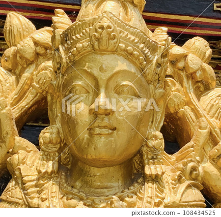 Balinese Hindu God golden Shiva Durga statue on a sacred Hindu temple in Indonesia Balinese Hindu God golden Shiva Durga statue on a sacred Hindu temple in Indonesia 108434525