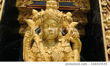 Balinese Hindu God golden Shiva Durga statue on a sacred Hindu temple in Indonesia 108434545