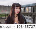 Asian woman in emo goth clothes at an abandoned building 108435727