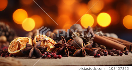 Traditional Christmas spices and dried orange slices on holiday bokeh background with defocus lights 108437223