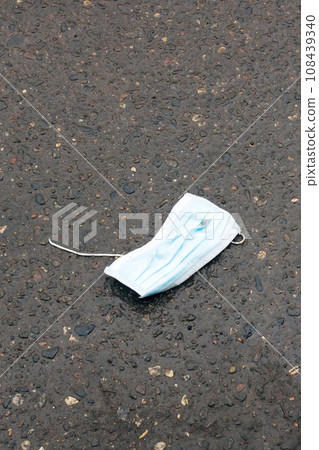 Old used medical mask on the asphalt Old used medical mask on the asphalt 108439340