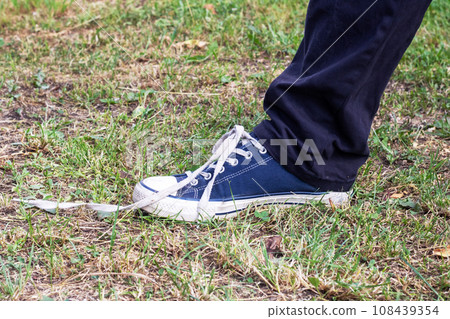 Lace was untied on boot on grass Lace was untied on boot on grass 108439354
