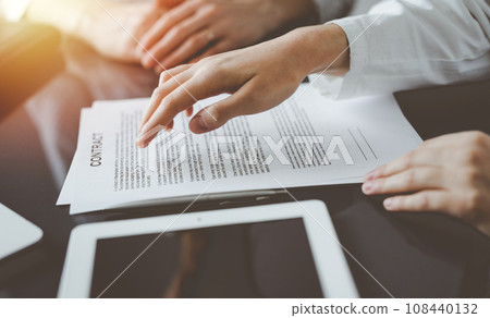 Business people discussing contract signing deal while sitting at the glass table in office, closeup. Partners or lawyers working together at meeting. Teamwork, partnership, success concept 108440132