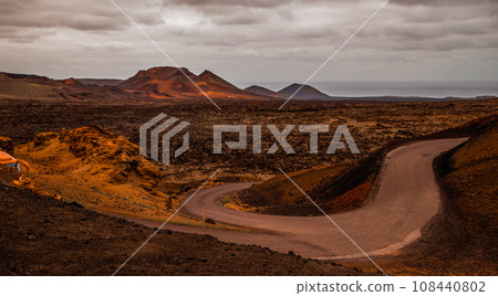 Amazing panoramic landscape of volcano in Timanfaya national park. Popular touristic in Lanzarote island Canary islans Spain. Artistic picture. Travel concept Amazing panoramic landscape of volcano in Timanfaya national park. Popular touristic in Lanzarote island Canary islans Spain. Artistic picture. Travel concept 108440802
