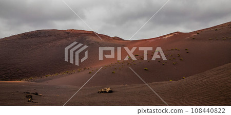 Amazing panoramic landscape of volcano in Timanfaya national park. Popular touristic in Lanzarote island Canary islans Spain. Artistic picture. Travel concept Amazing panoramic landscape of volcano in Timanfaya national park. Popular touristic in Lanzarote island Canary islans Spain. Artistic picture. Travel concept 108440822