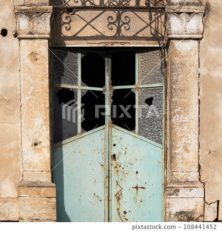 Window with a broken glass in an ancient building 108441452