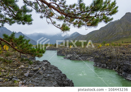 Scenic view of Katun river flowing amidst rocky coastlines with mountains in background at Altai, Russia Scenic view of Katun river flowing amidst rocky coastlines with mountains in background at Altai, Russia 108443236