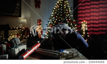 little boy sleeping on his desk in Christmas 108444008