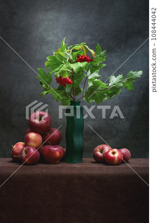 Still life with a branch of viburnum and apples 108444042