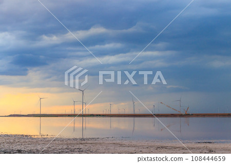 Building and assembling a construction wind turbines farm by a crane 108444659