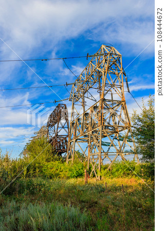 High voltage power line against blue sky 108444672