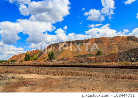 View of slag heaps of iron ore quarry. Mining industry View of slag heaps of iron ore quarry. Mining industry 108444731