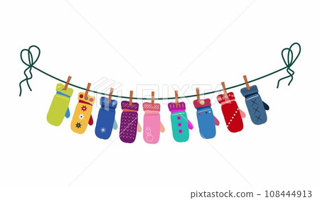 Different mittens hanging on the rope. Wool winter gloves mittens dry and hang on laundry string with clothespins. 108444913