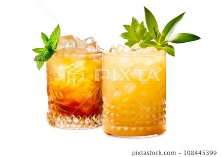Set of Mai Tai cocktails in a classic tiki glass with crushed ice and a fresh mint Set of Mai Tai cocktails in a classic tiki glass with crushed ice and a fresh mint 108445399