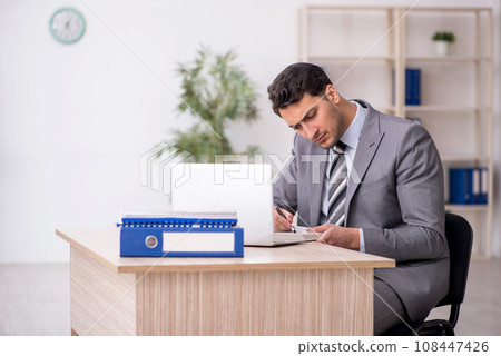Young male employee working in the office Young male employee working in the office 108447426