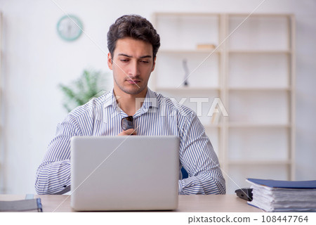 Young male employee working in the office 108447764