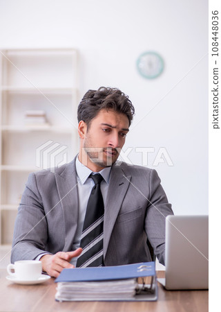 Young male employee working in the office Young male employee working in the office 108448036