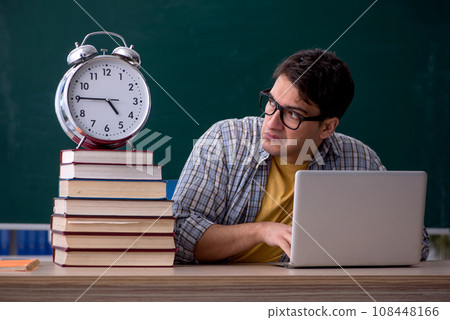 Young male student in time management concept 108448166