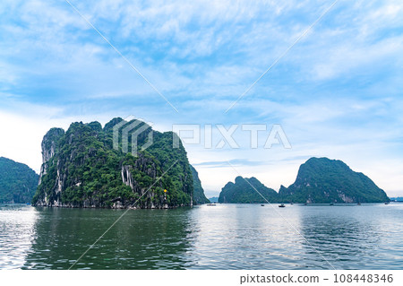 Strangely shaped rocks and fishing boats in Ha Long Bay, Vietnam 108448346