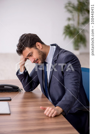 Young male employee working in the office Young male employee working in the office 108448451