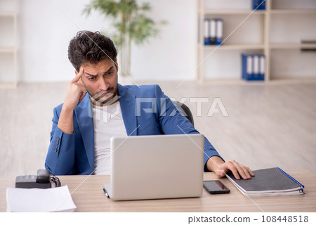 Young male employee working in the office 108448518