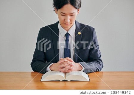 Male lawyer reading the complete book of the Six Codes Male lawyer reading the complete book of the Six Codes 108449342