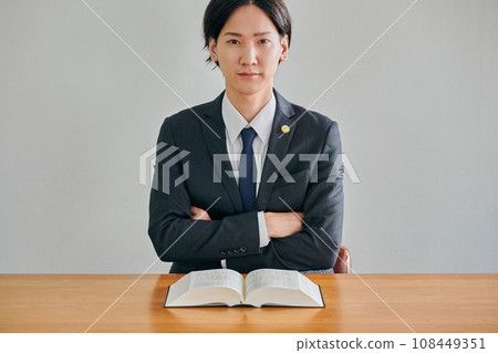 Male lawyer thinking with arms folded Male lawyer thinking with arms folded 108449351