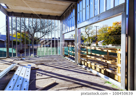 In process of constructing an industrial commercial building steel framework frame beams are being erected 108450639