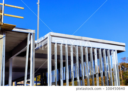 Construction of an industrial commercial building is framed with steel beams frames Construction of an industrial commercial building is framed with steel beams frames 108450640