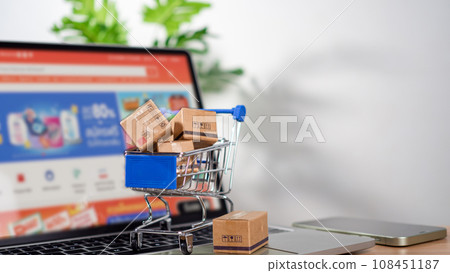Shopping cart and product boxes placed on laptop computer represent online shopping concept, website, e-commerce, marketplace platform, technology, transportation, logistics and online payment Shopping cart and product boxes placed on laptop computer represent online shopping concept, website, e-commerce, marketplace platform, technology, transportation, logistics and online payment 108451187
