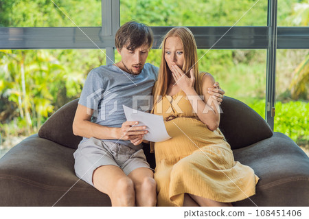 Cost of Pregnancy And Family Budgeting Concept. Young couple expecting baby, planning budget and counting spends at home Cost of Pregnancy And Family Budgeting Concept. Young couple expecting baby, planning budget and counting spends at home 108451406