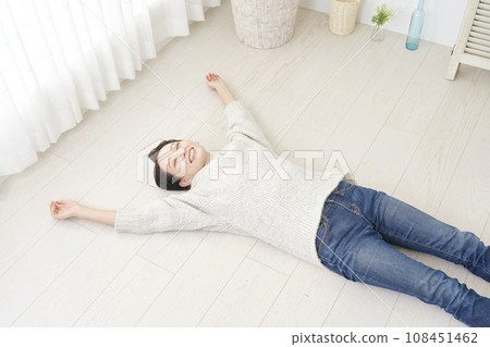 Floor heating image: Woman lying on the flooring Floor heating image: Woman lying on the flooring 108451462