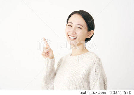Middle-aged woman pointing to the left white background Middle-aged woman pointing to the left white background 108451538