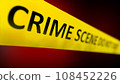 Close up a yellow crime scene tape with the words CRIME SCENE DO NOT CROSS written on it. Shallow depth of field. 108452226