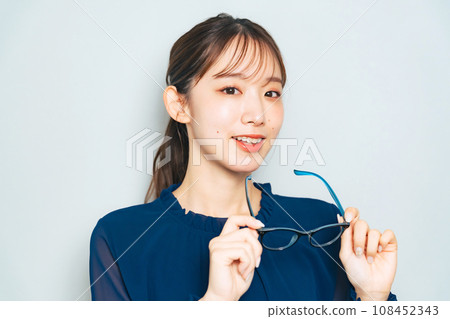 woman taking off glasses woman taking off glasses 108452343