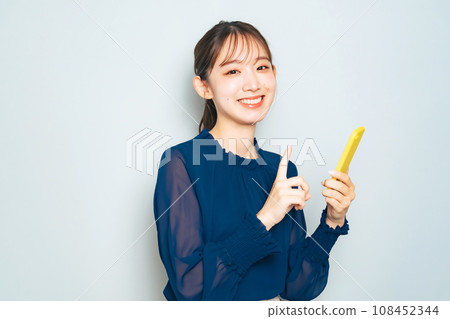 A woman using a smartphone 108452344