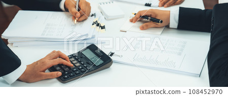 Corporate accountant team use calculator to calculate financial report. Shrewd Corporate accountant team use calculator to calculate financial report. Shrewd 108452970