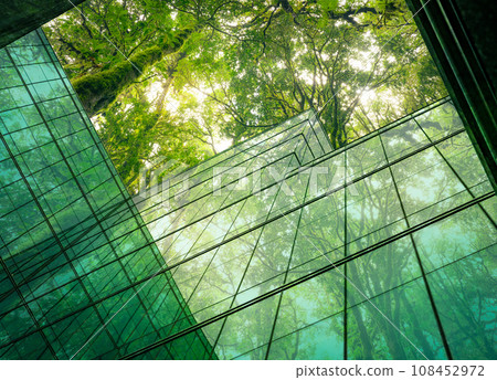 Eco-friendly building in the modern city. Sustainable glass office building with tree for reducing heat and carbon dioxide. Office building with green environment. Corporate building reduce CO2. 108452972