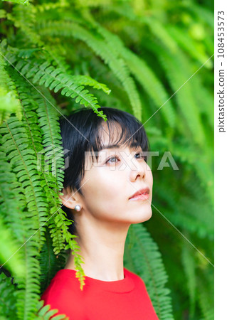 Portrait of a woman surrounded by greenery 108453573